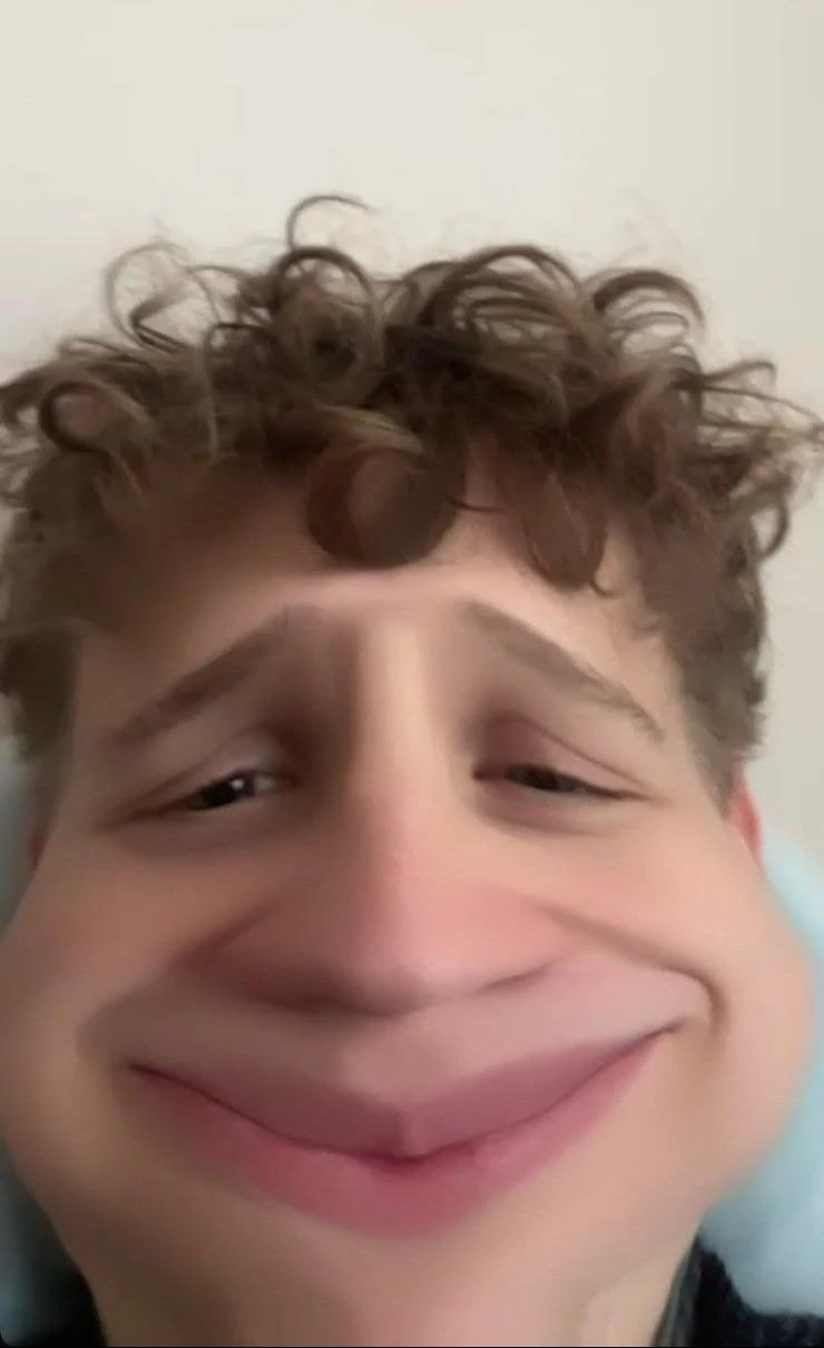 Sami making a silly smiling face with a playful filter